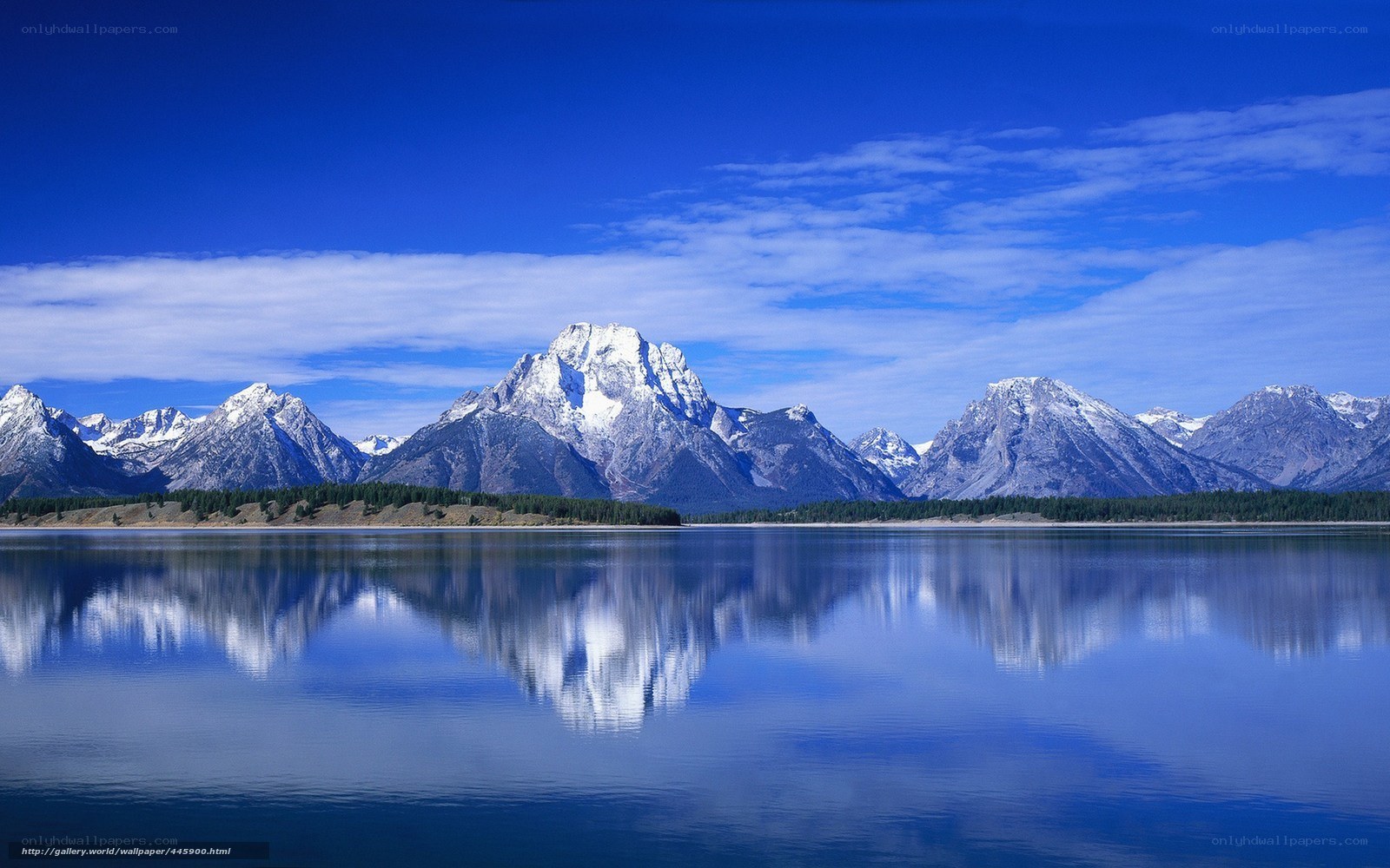 Snow-capped mountains reflected in lake