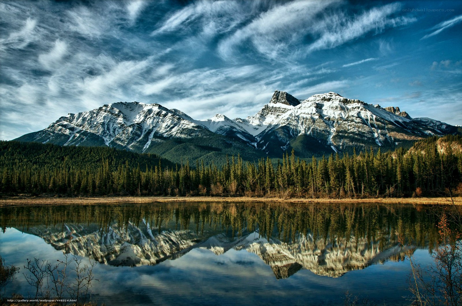 Snow-capped mountains reflected in lake