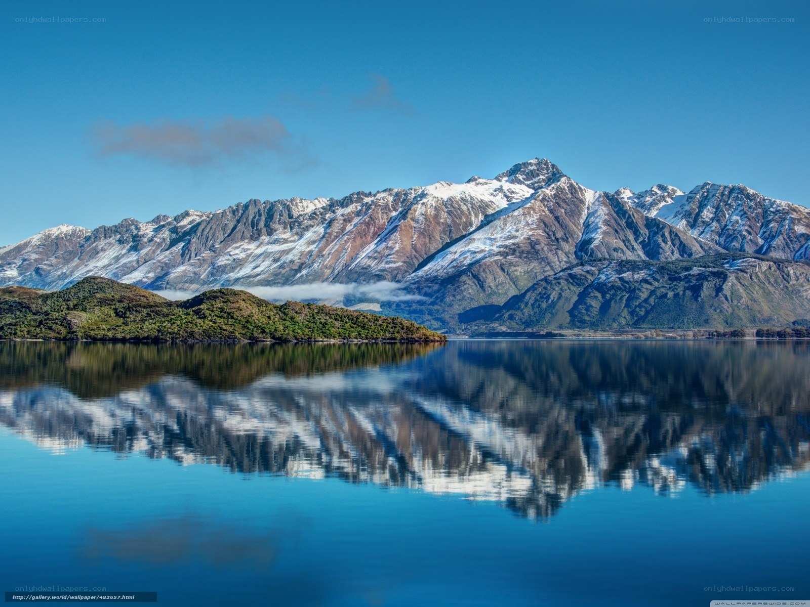 Snow-capped mountains reflected in lake