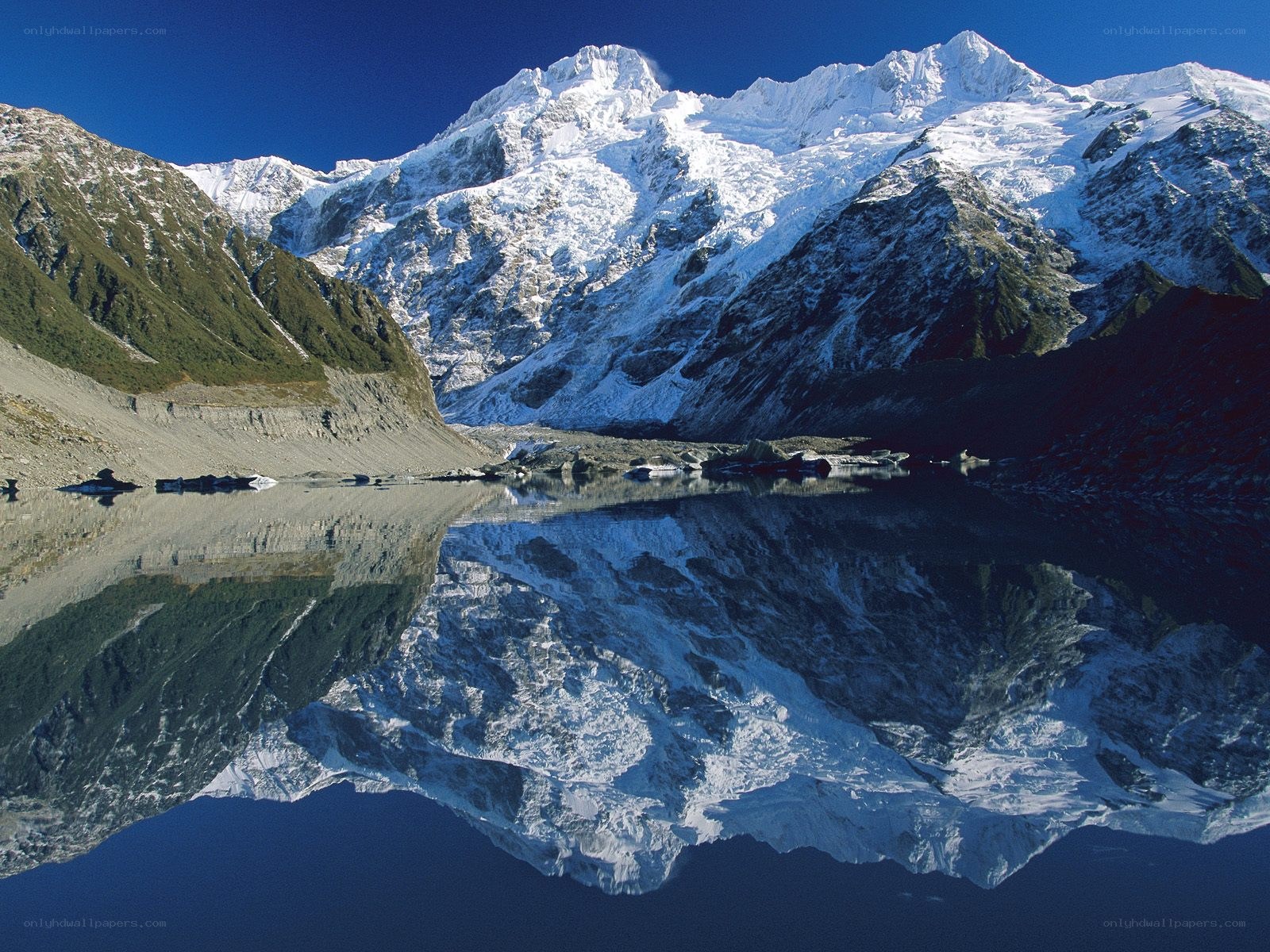 Snow-capped mountains reflected in lake