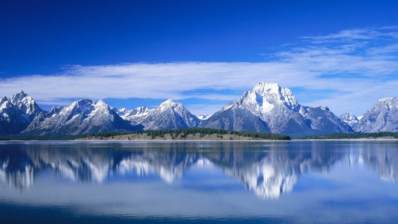 Snow-capped mountains reflected in lake