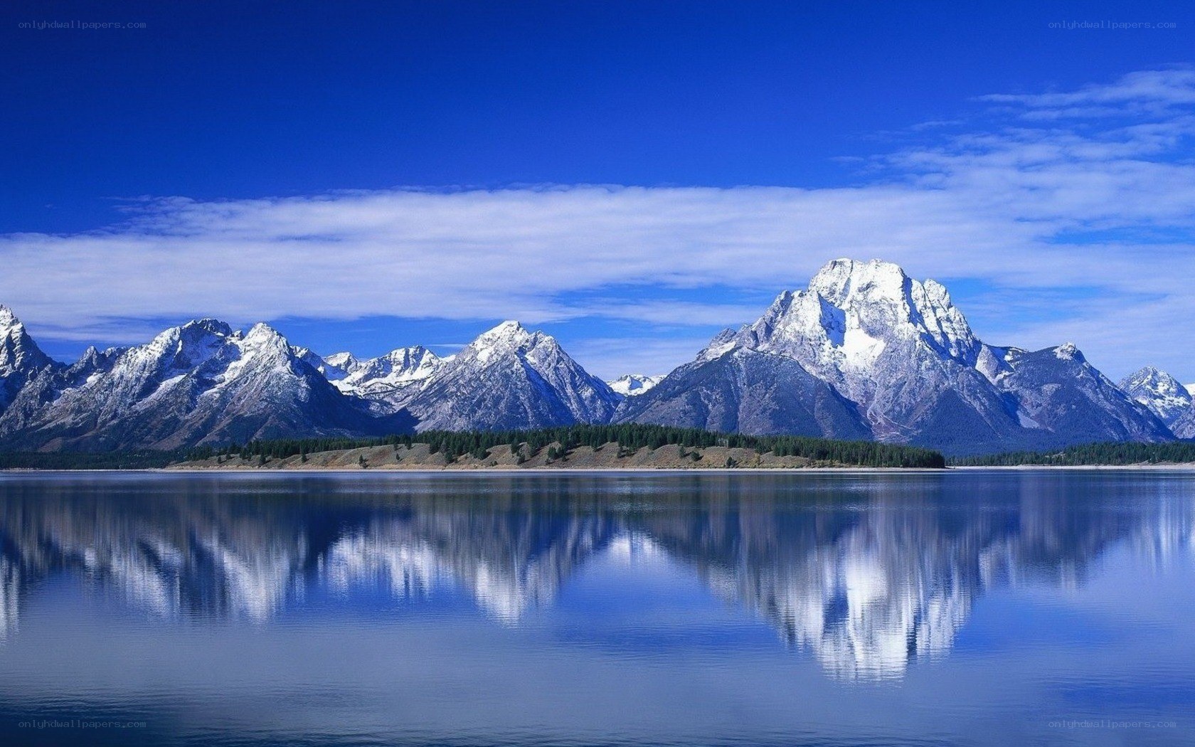 Snow-capped mountains reflected in lake