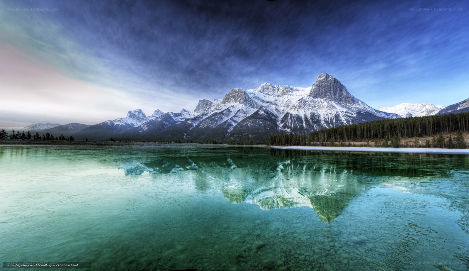 Snow-capped mountains reflected in lake