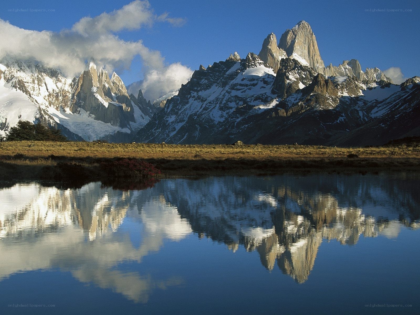 Snow-capped mountains reflected in lake