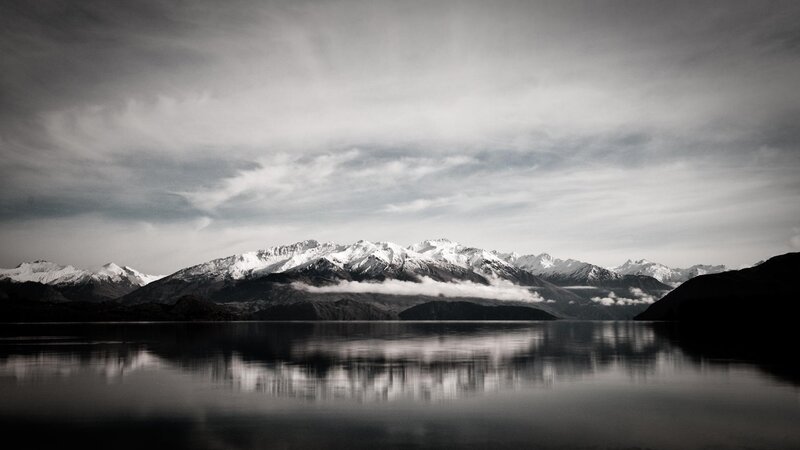 Snow-capped mountains reflected in lake