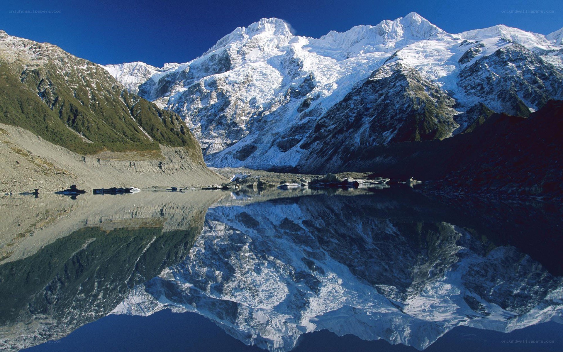 snow-capped mountains reflected in lake