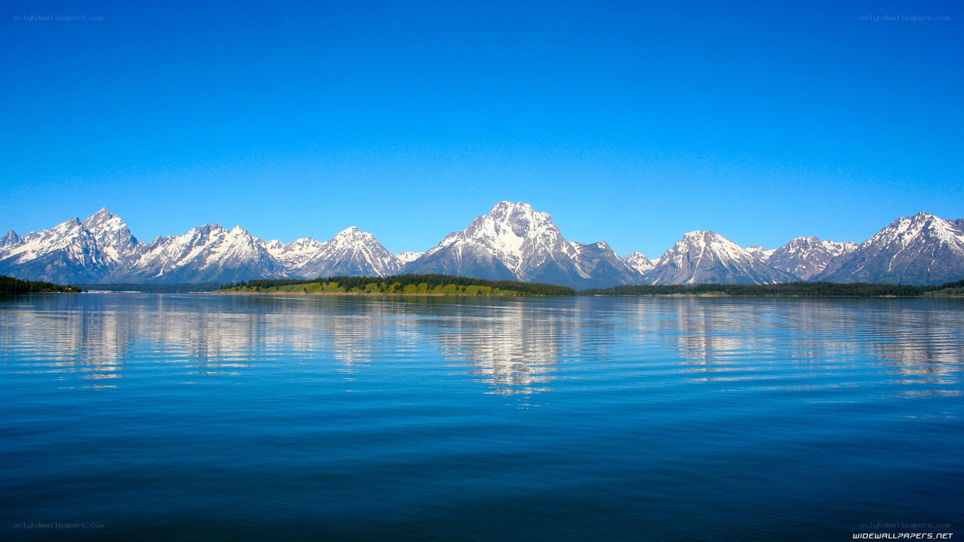 snow-capped mountains reflected in lake