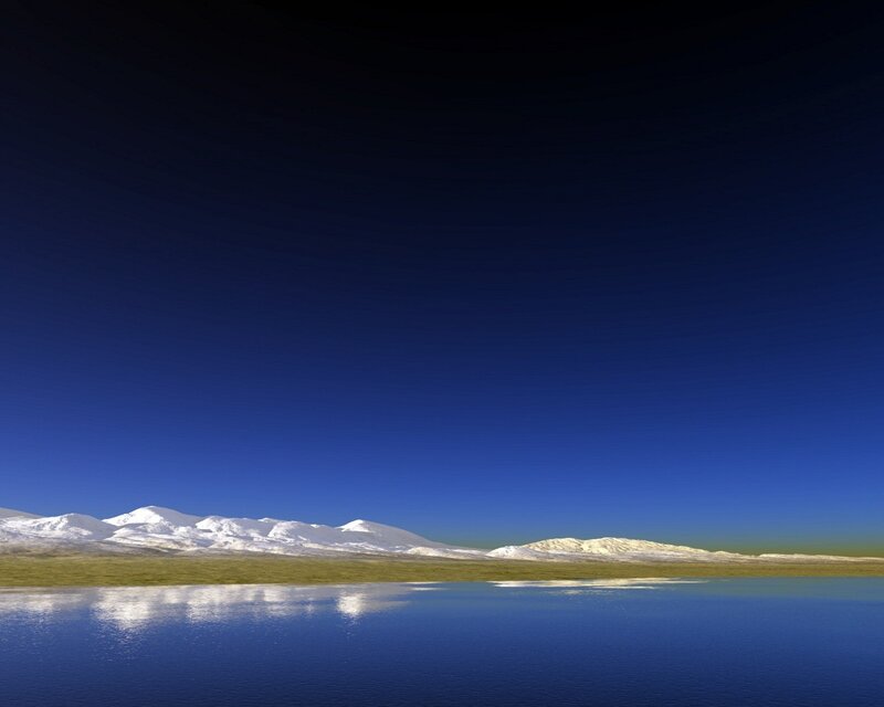 Snow-capped mountains reflected in lake
