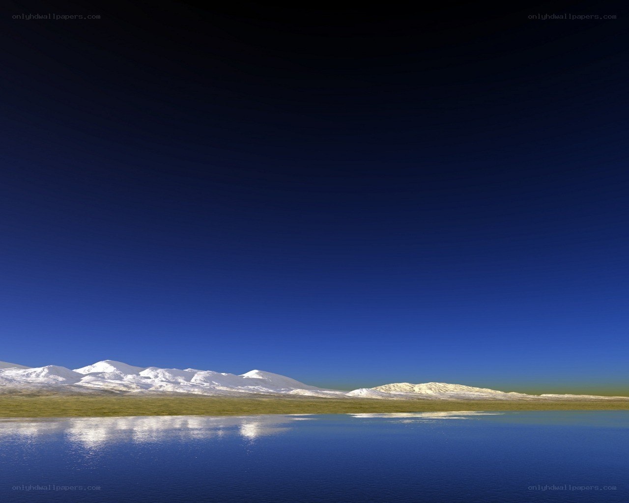 Snow-capped mountains reflected in lake