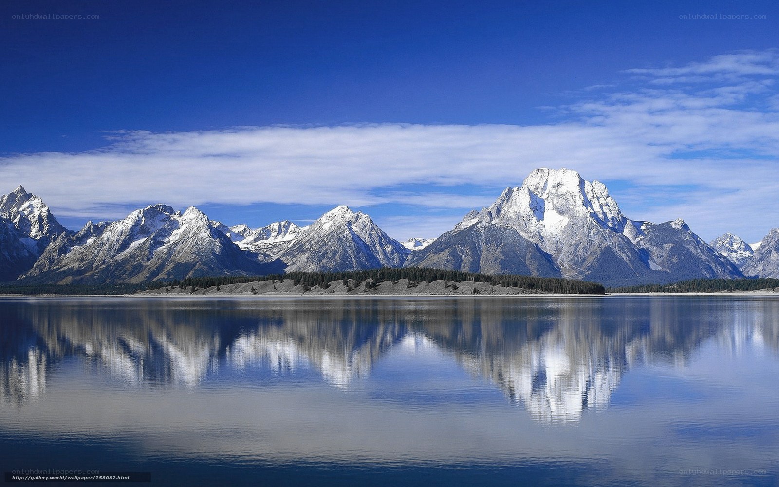 Snow-capped mountains reflected in lake