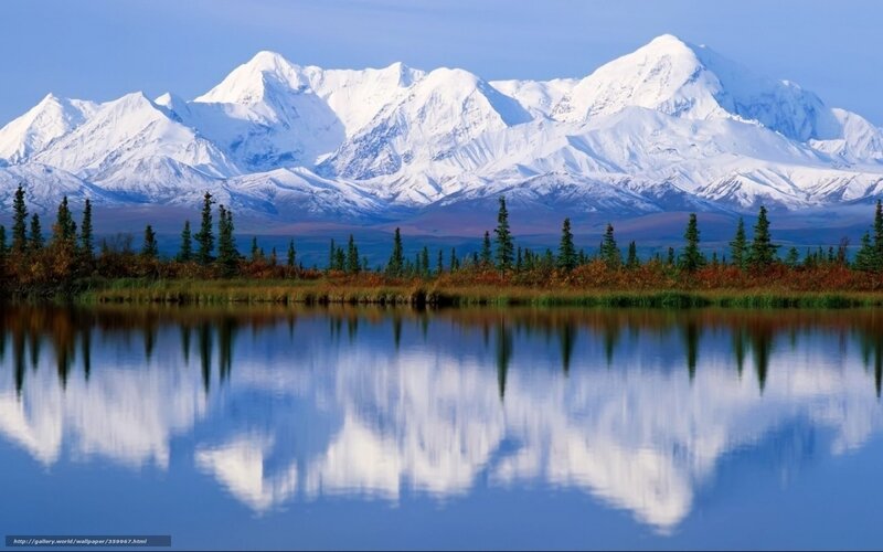 Snow-capped mountains reflected in lake