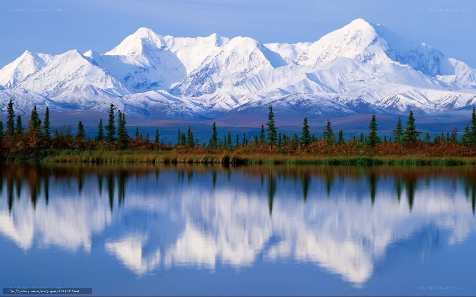 Snow-capped mountains reflected in lake