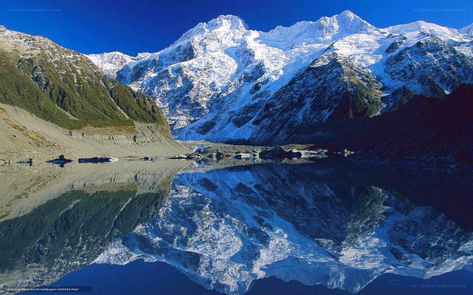 Snow-capped mountains reflected in lake
