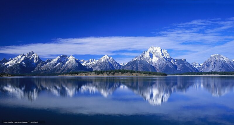 Snow-capped mountains reflected in lake