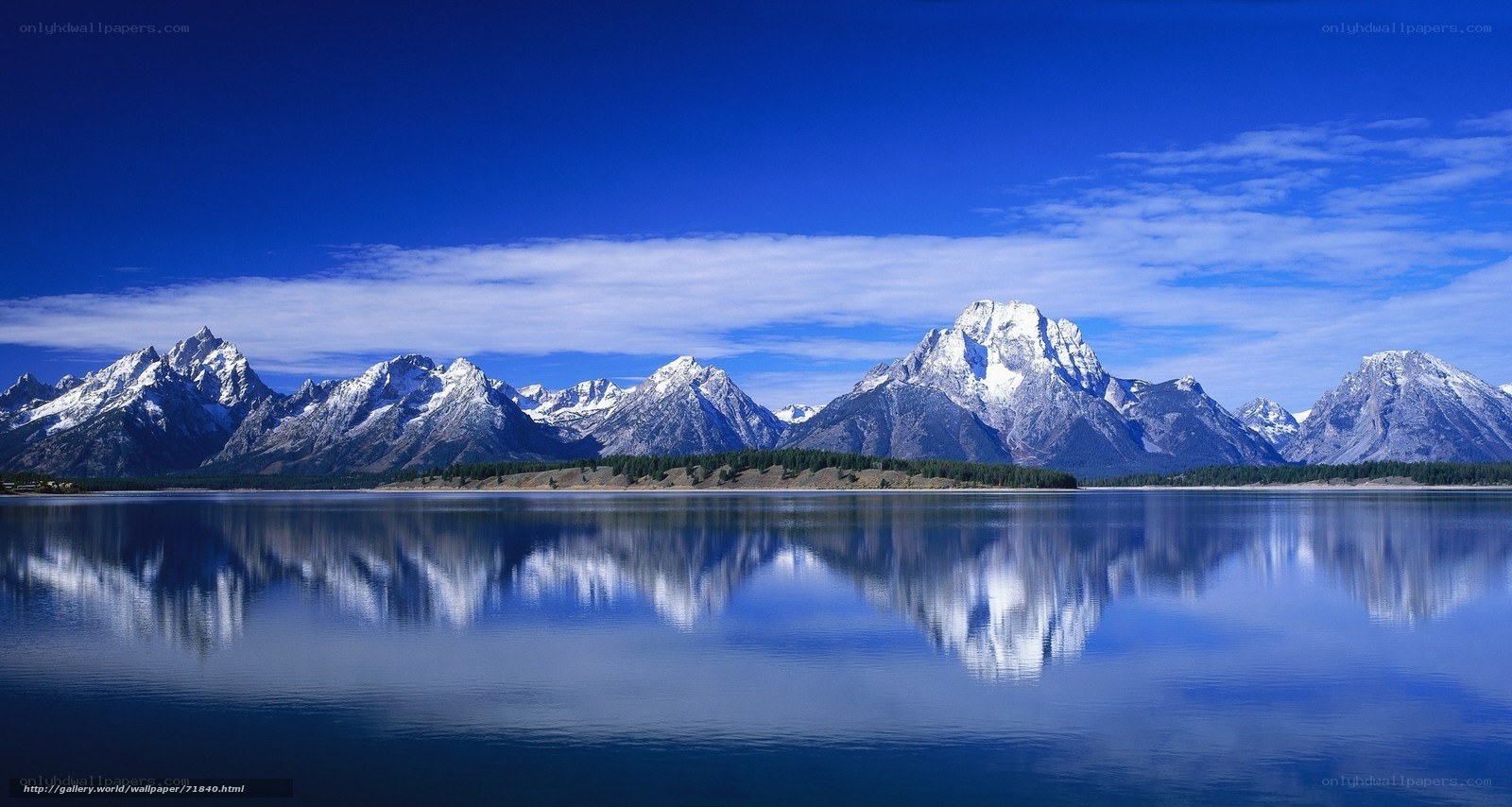 Snow-capped mountains reflected in lake