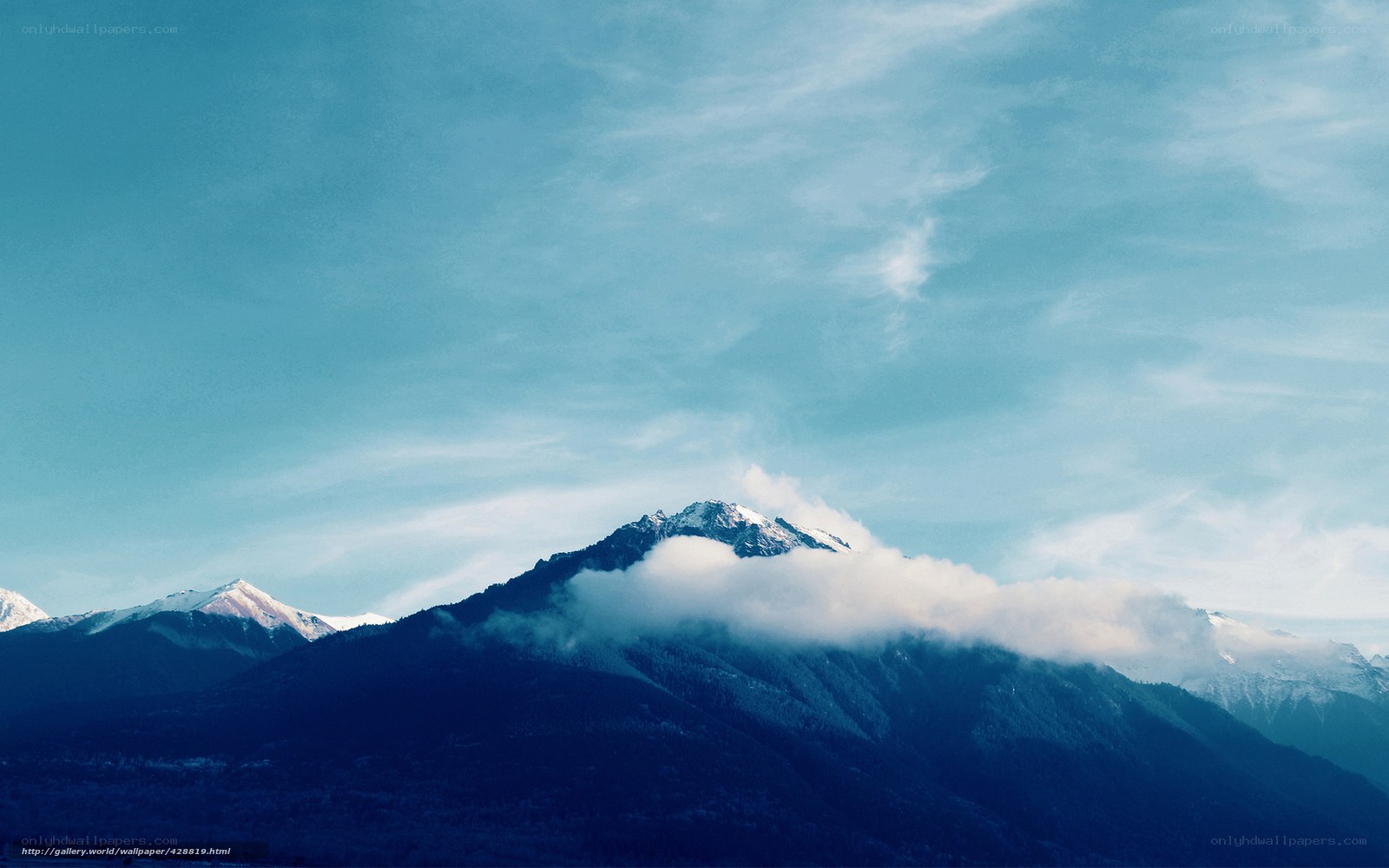Snow-capped mountains under blue sky