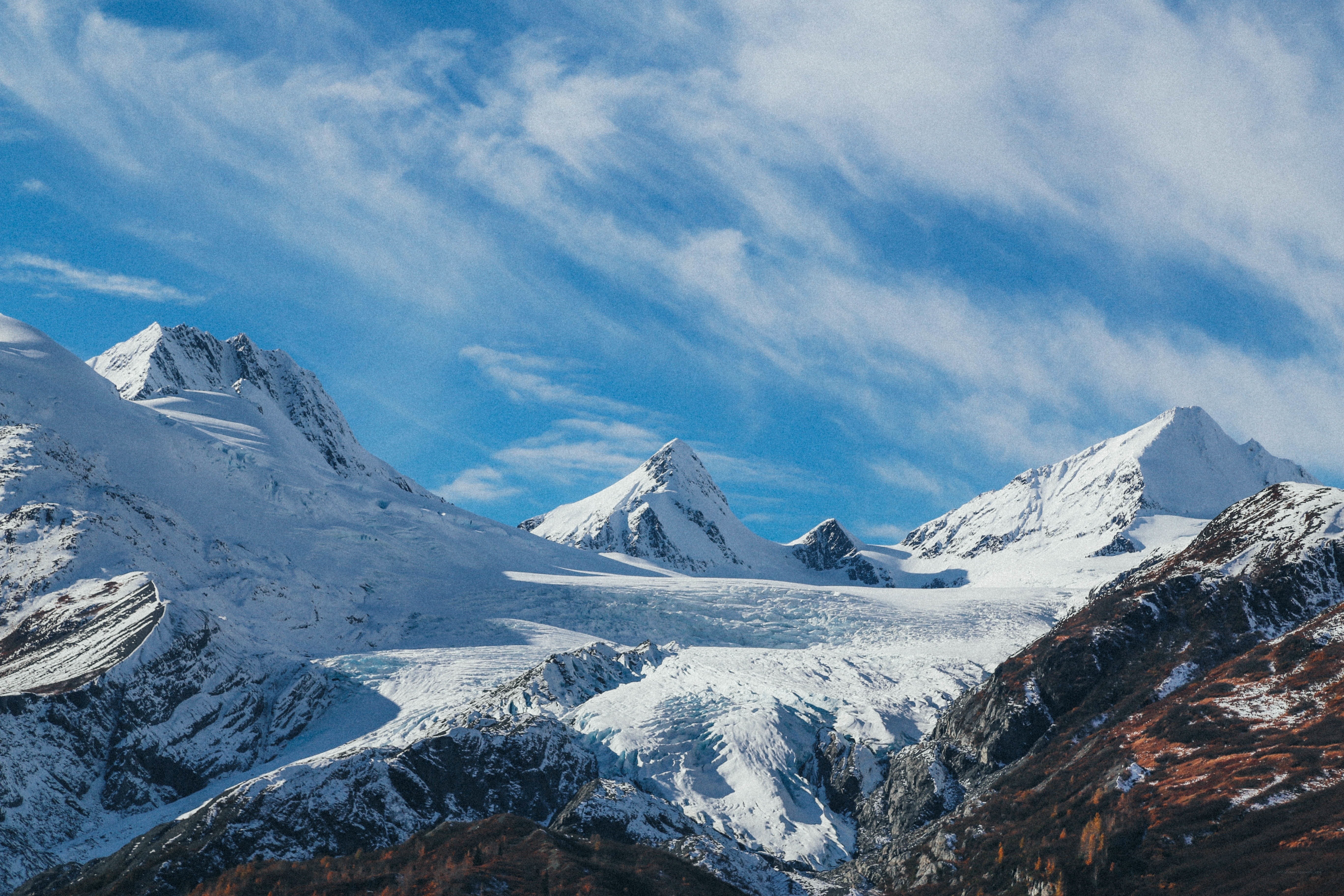 Snow-capped mountains under blue sky