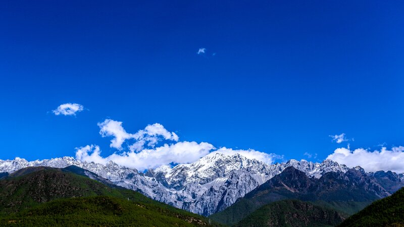 Snow-capped mountains under blue sky