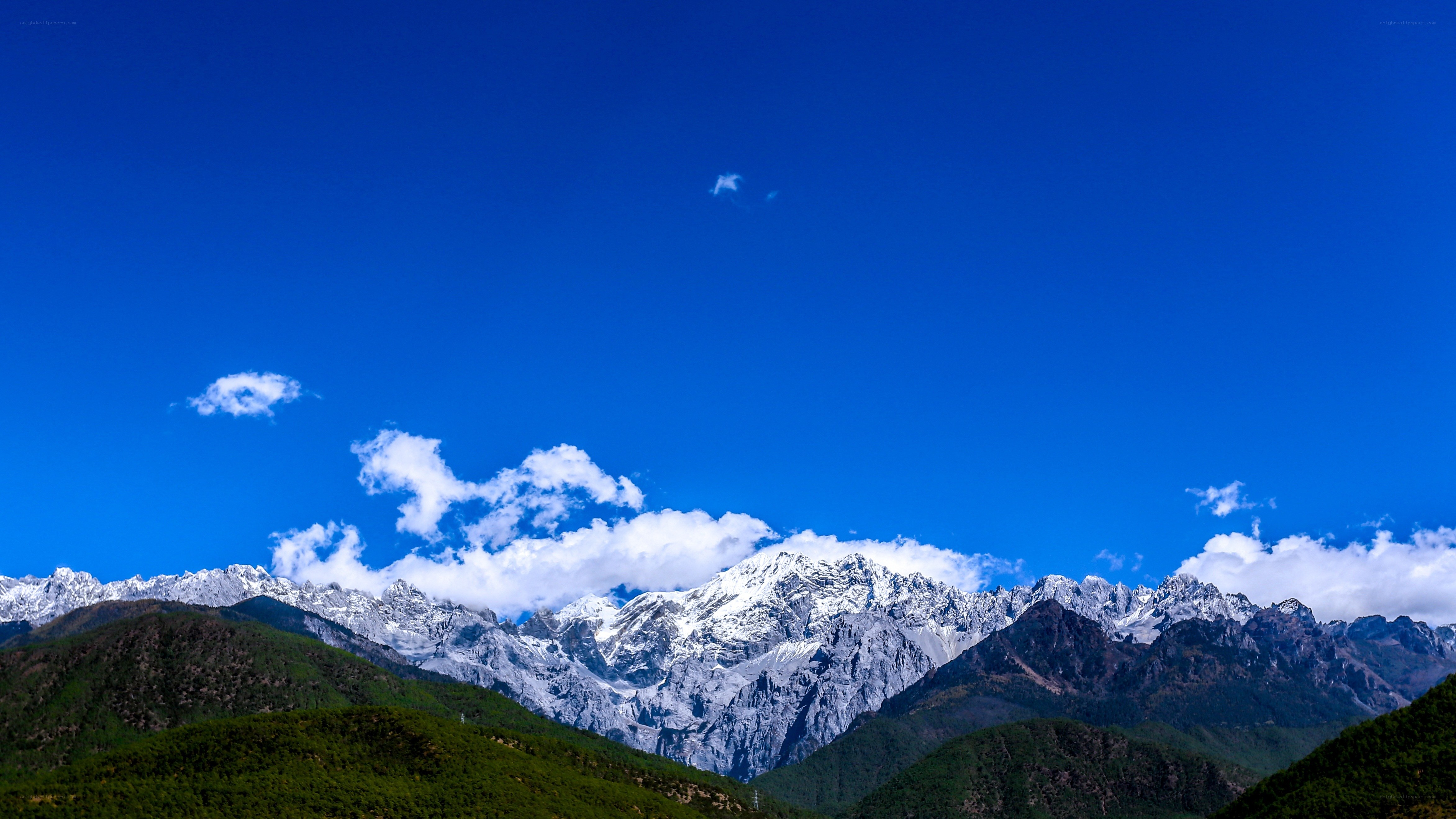 Snow-capped mountains under blue sky