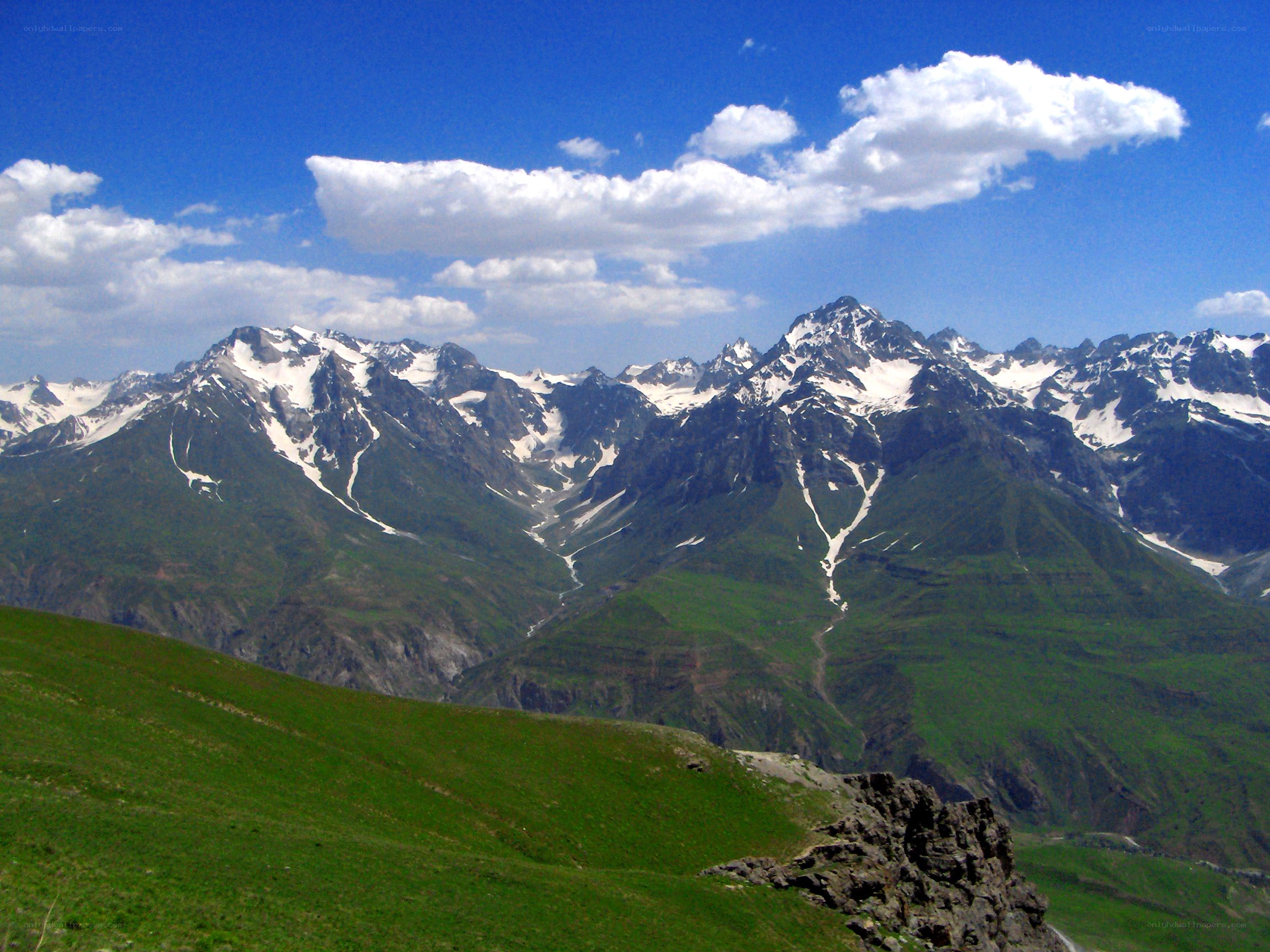 snow-capped mountains under blue sky