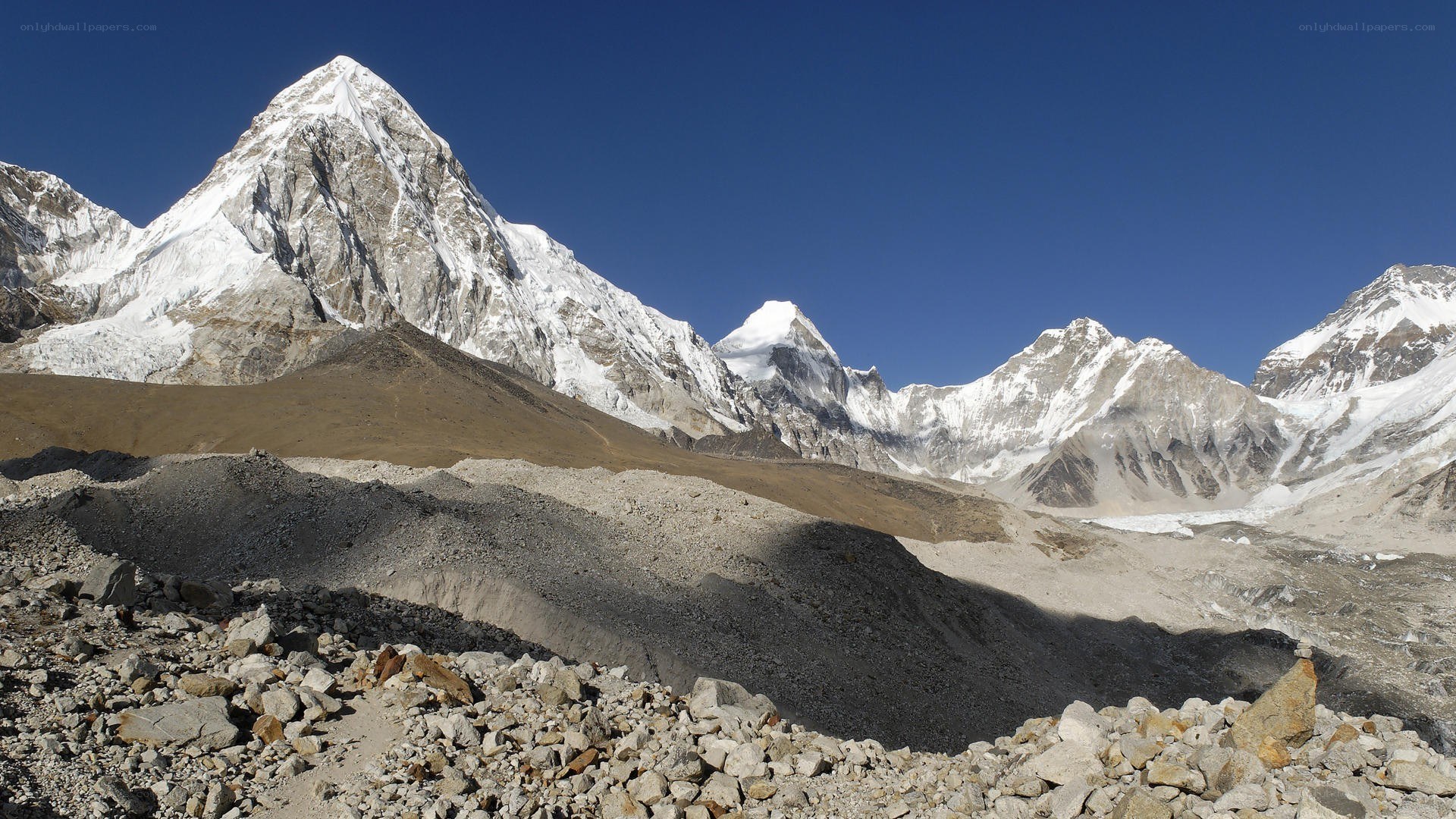 Snow-capped mountains under blue sky