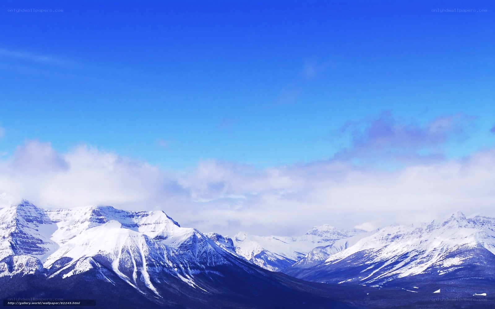 Snow-capped mountains under blue sky