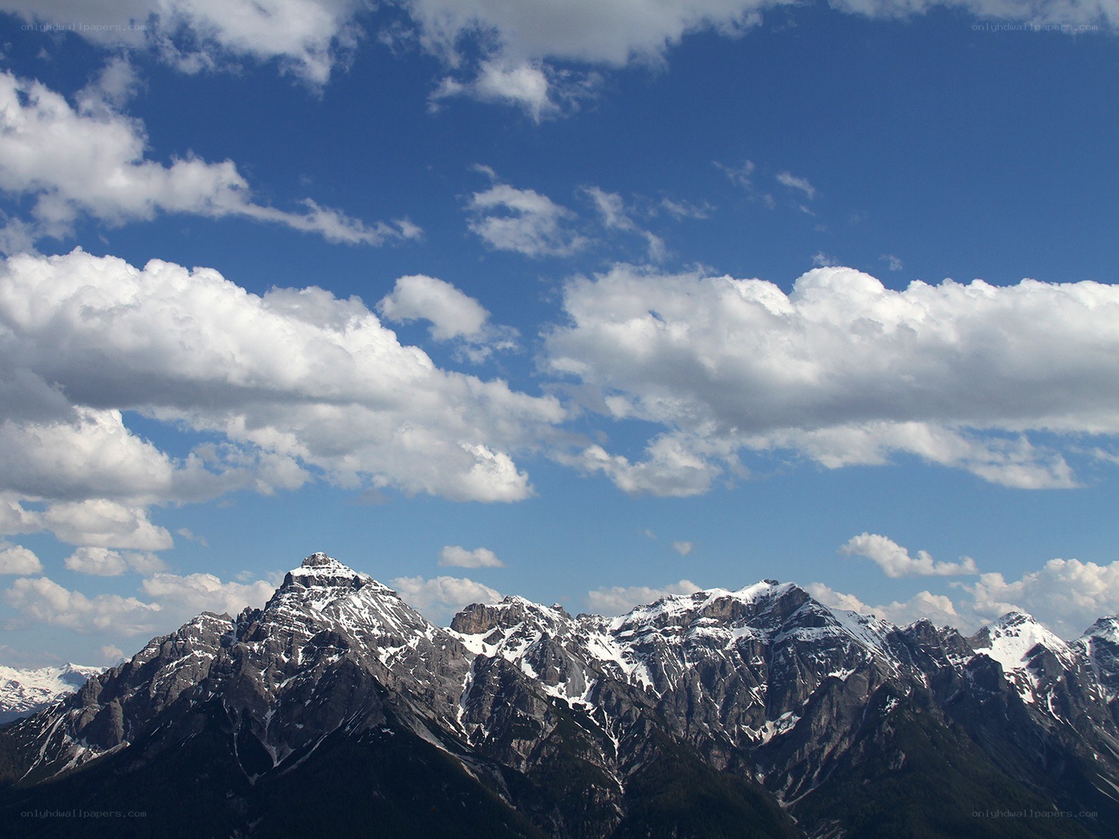 Snow-capped mountains under blue sky