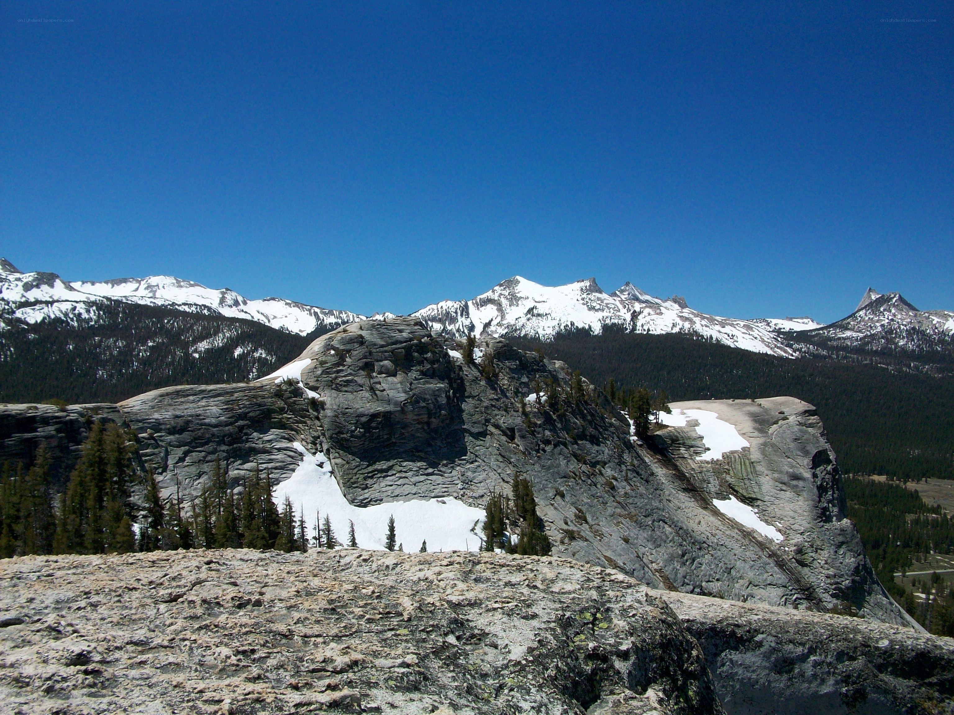 Snow-capped mountains under blue sky