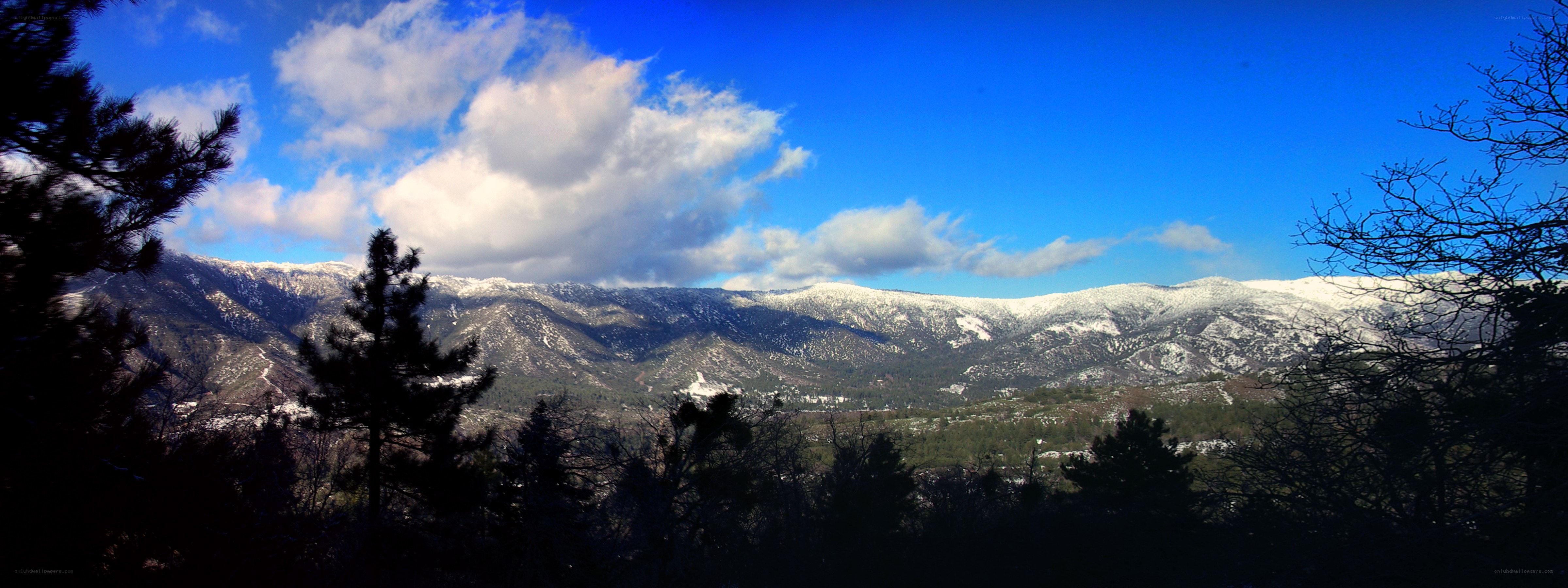 Snow-capped mountains under blue sky