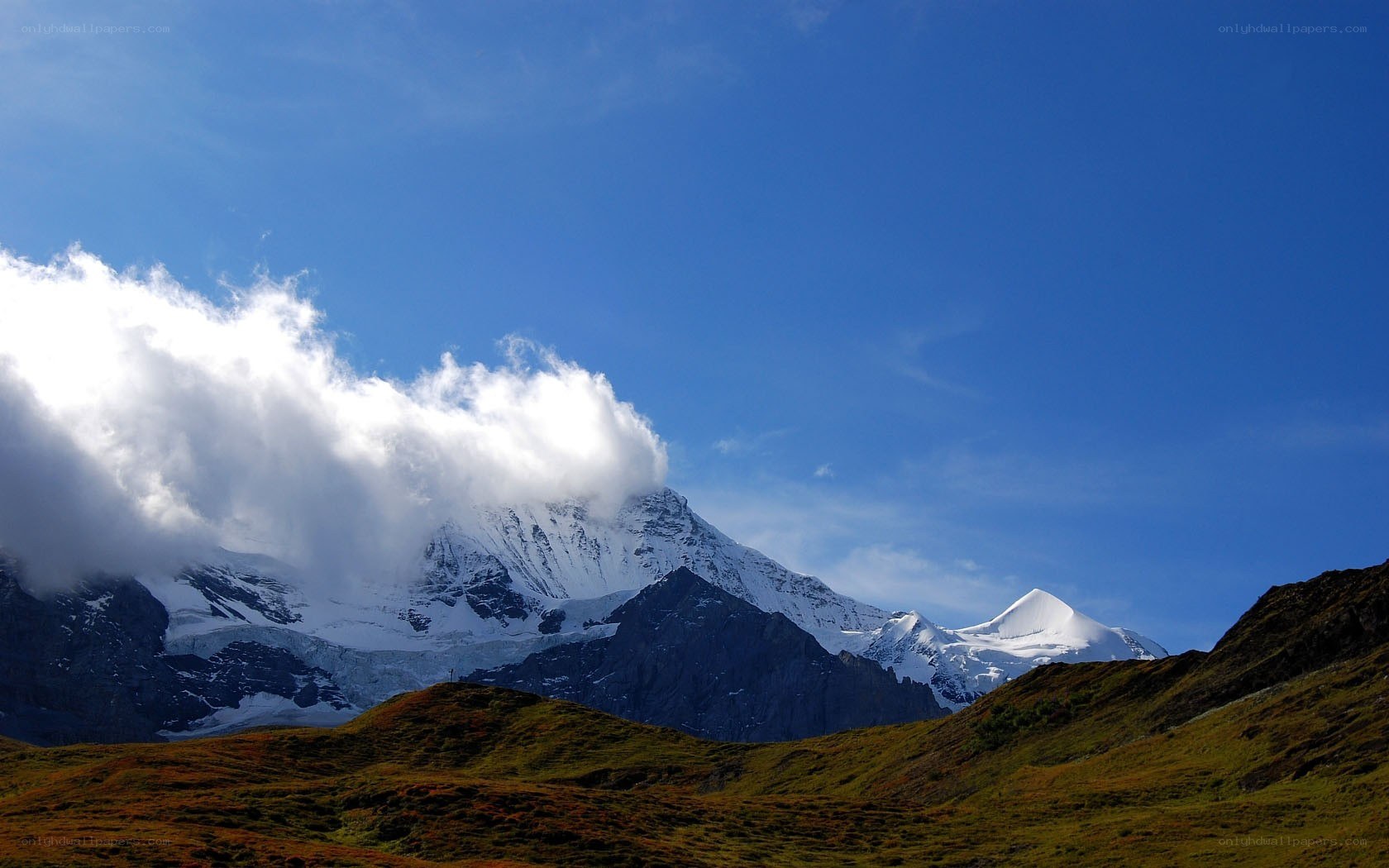 Snow-capped mountains under blue sky