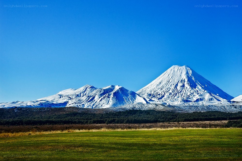 Snow-capped mountains under blue sky