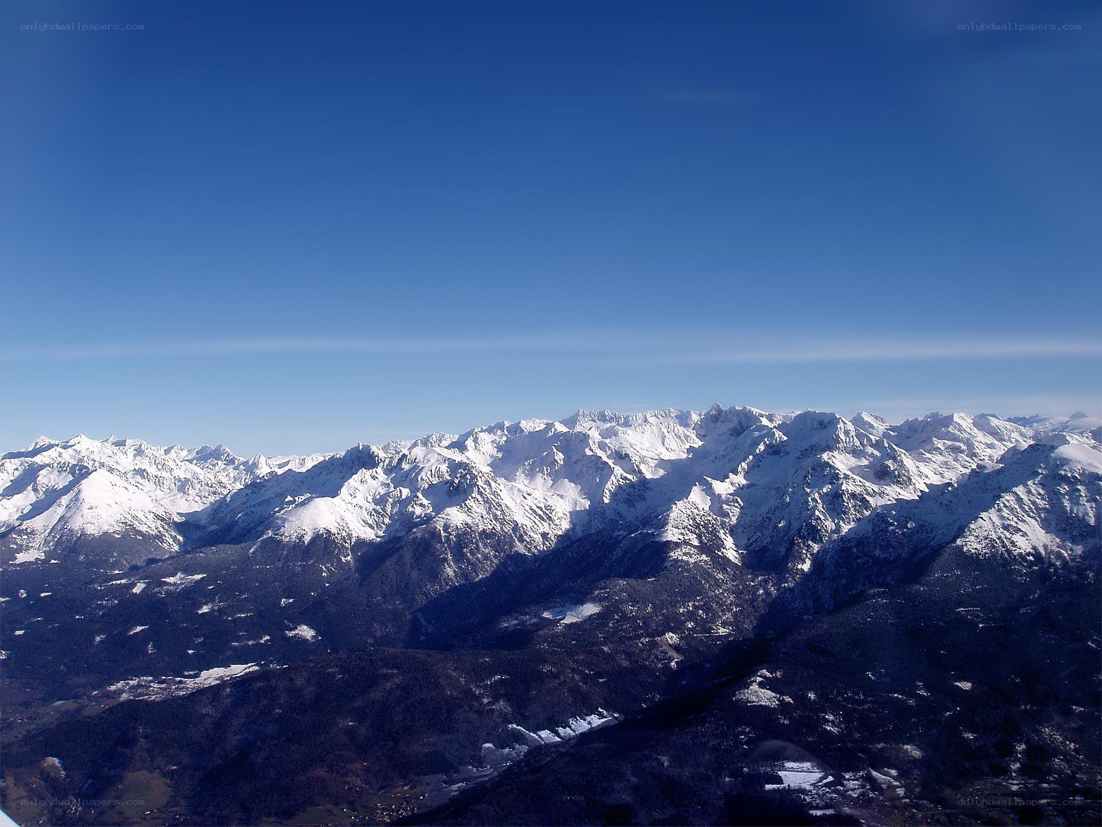 snow-capped mountains under blue sky