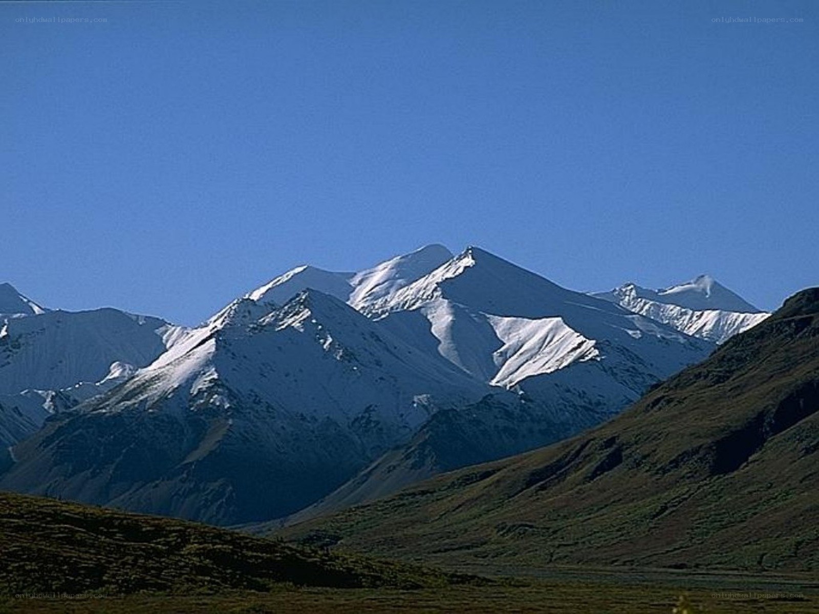 snow-capped mountains under blue sky