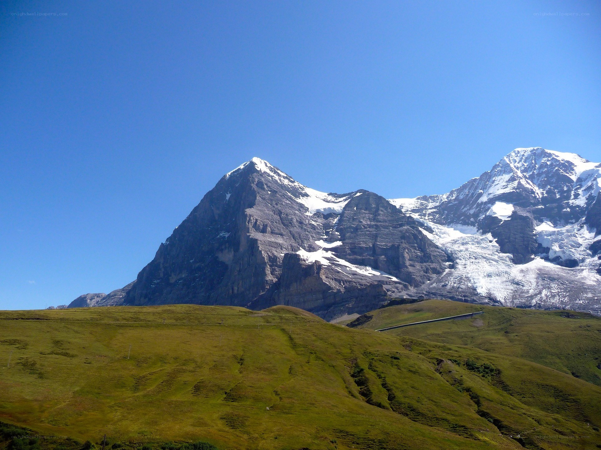 Snow-capped mountains under blue sky