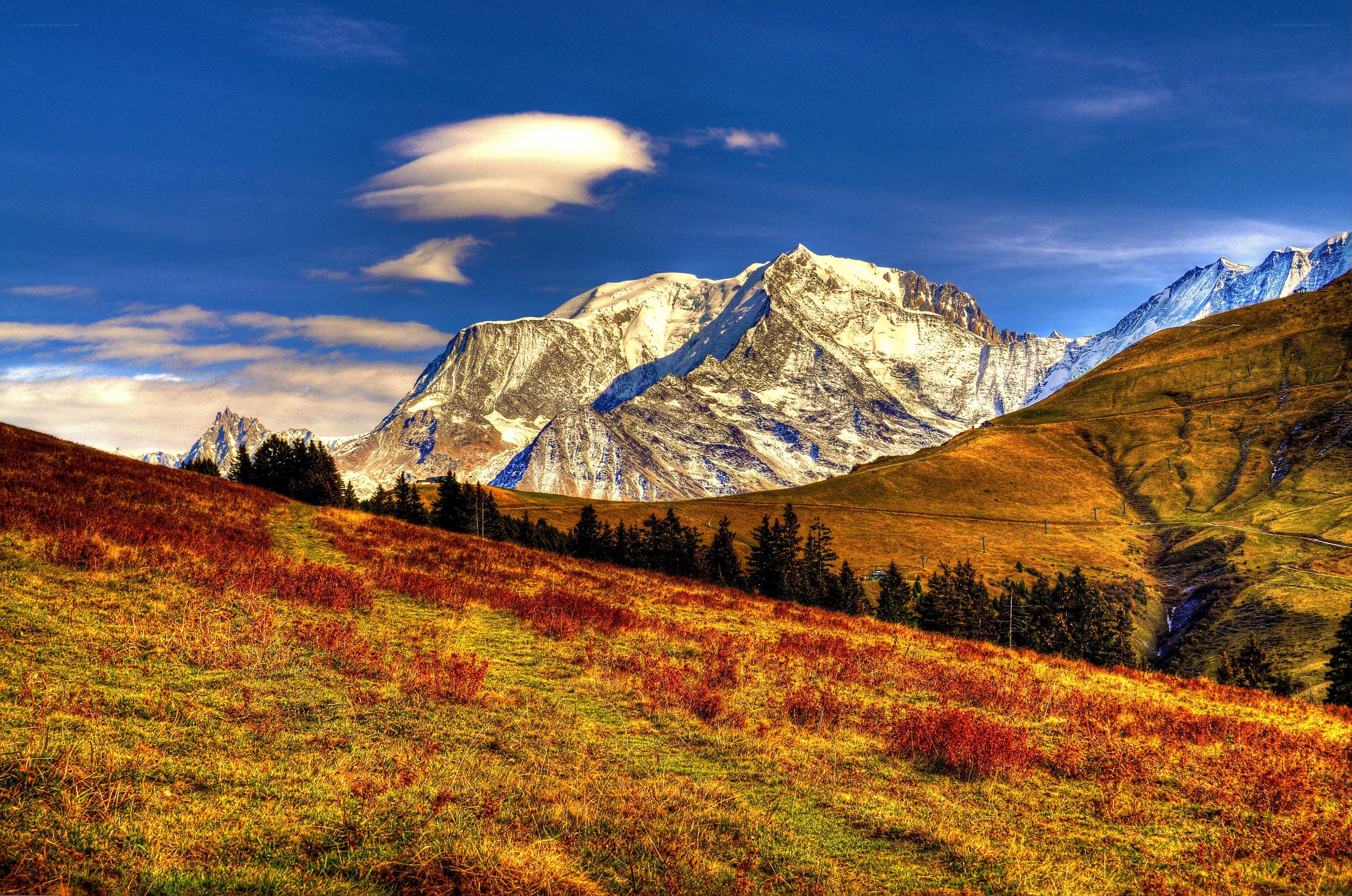 Snow-capped mountains under blue sky