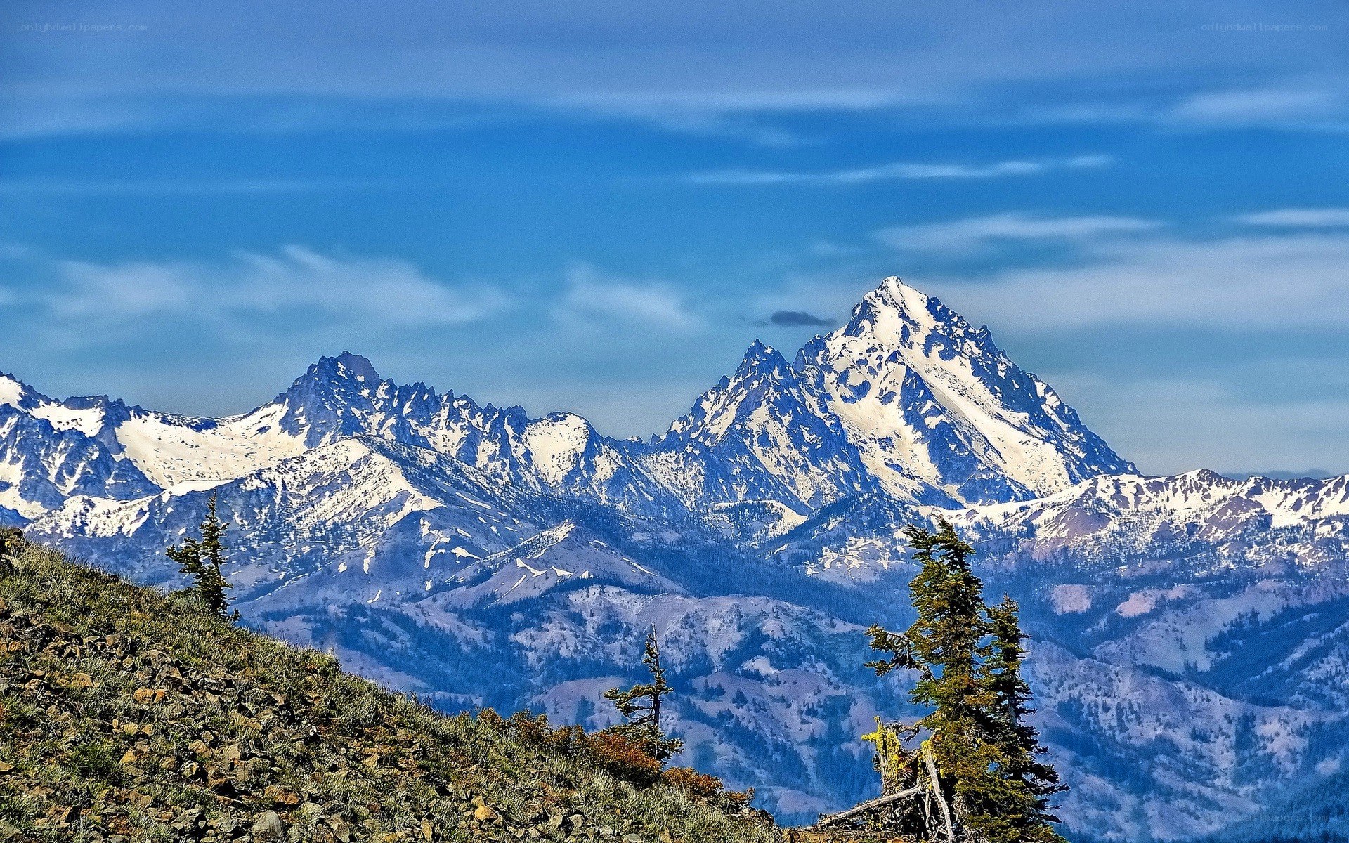 Snow-capped mountains under blue sky