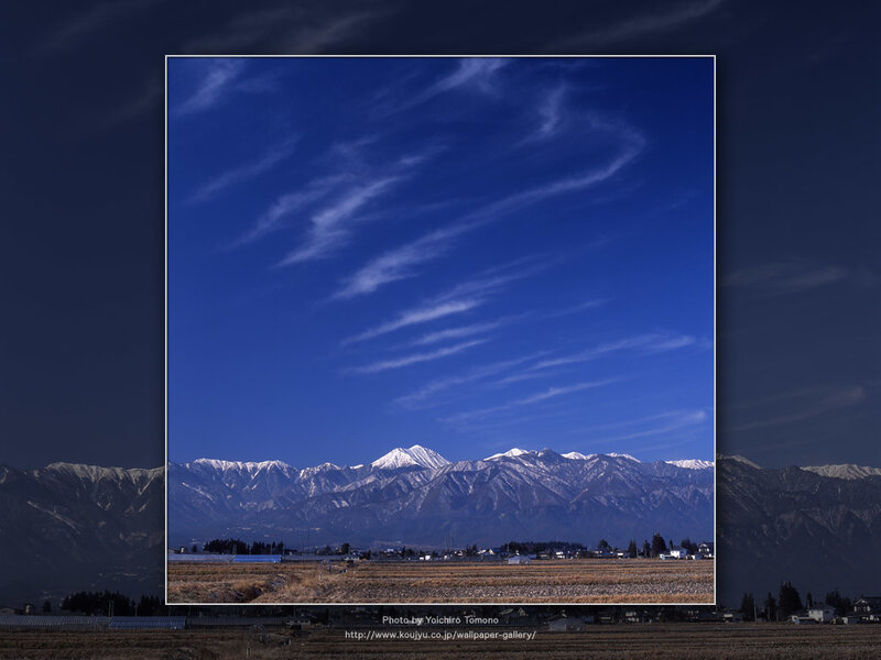 Snow-capped mountains under blue sky