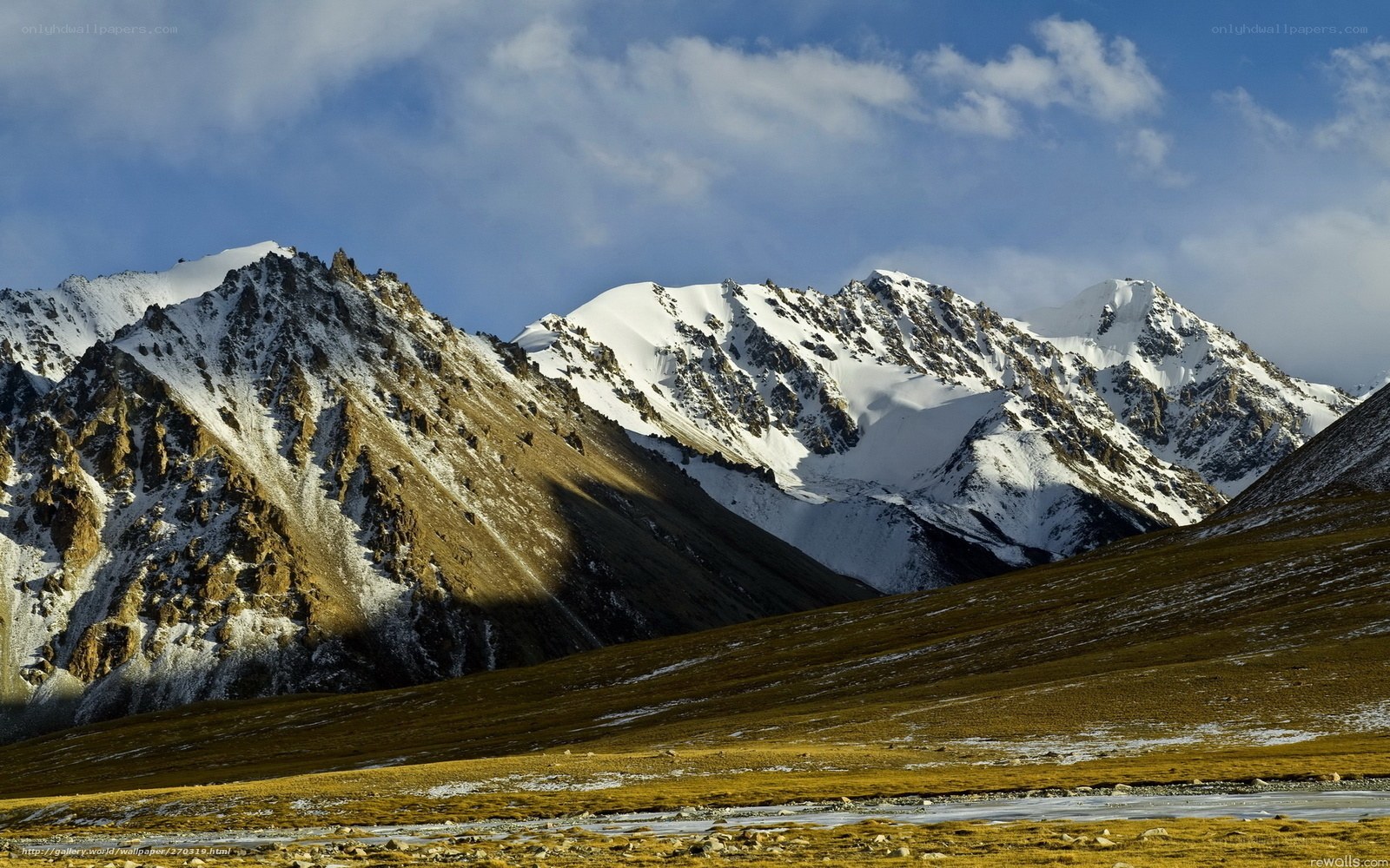 Snow-capped mountains under blue sky