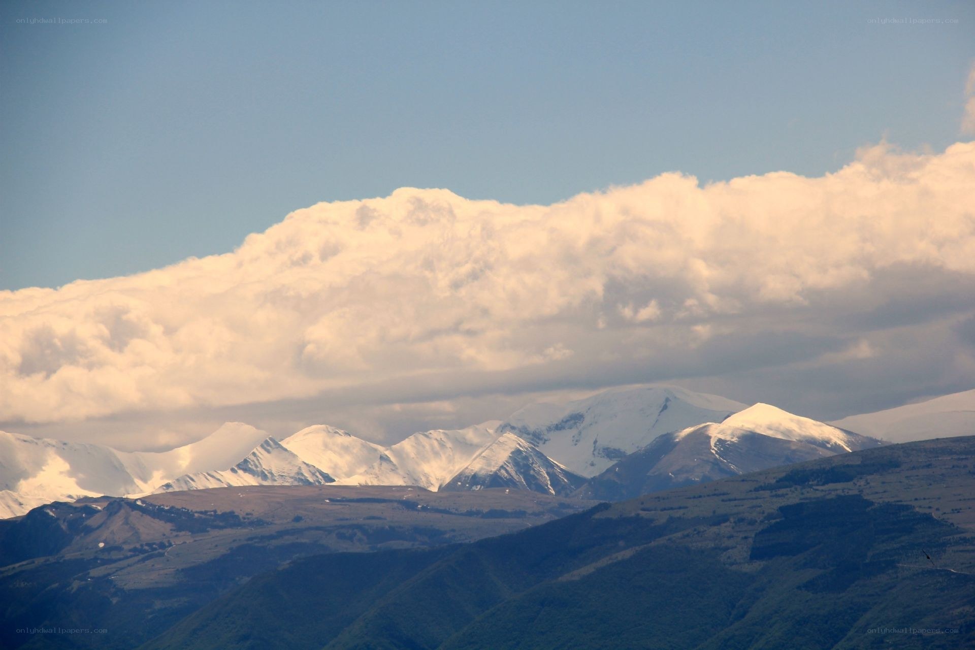 Snow-capped mountains under clouds