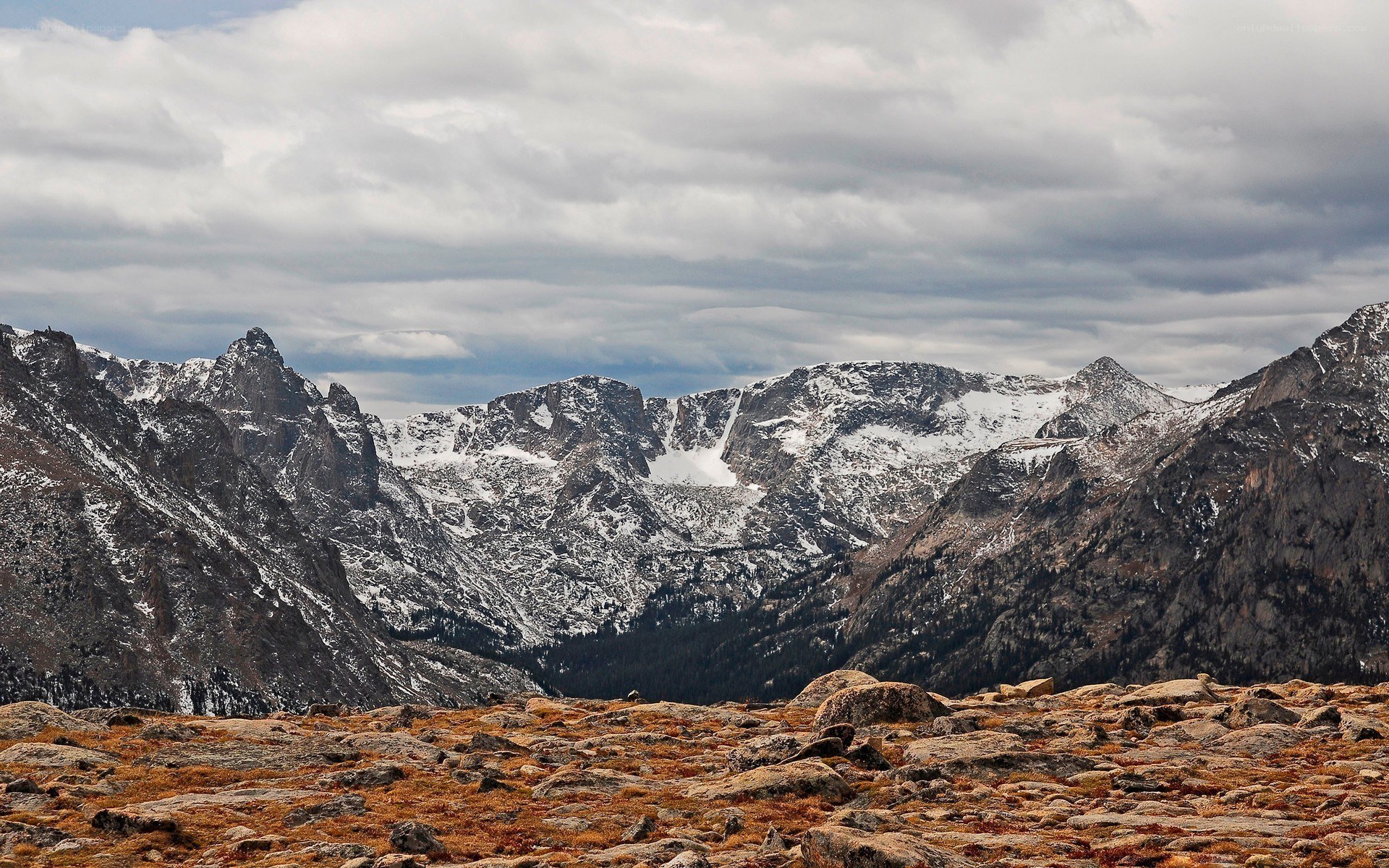 snow-capped mountains under cloudy sky