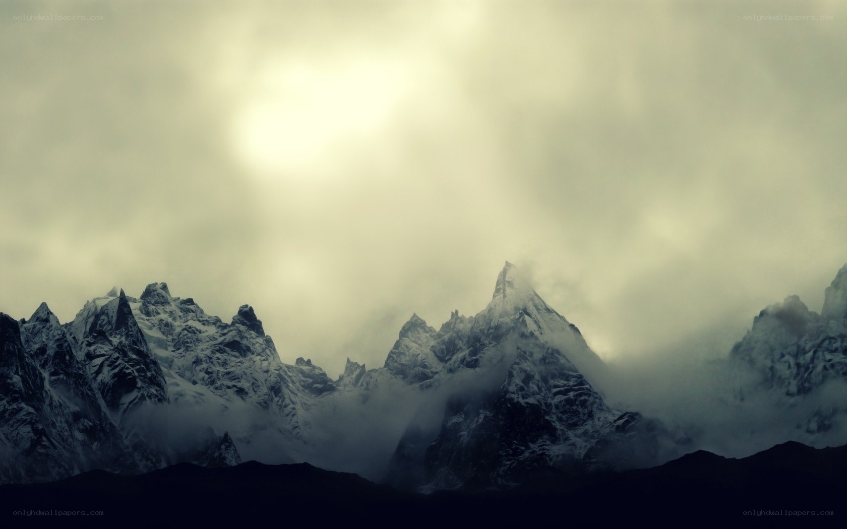 snow-capped mountains under cloudy sky