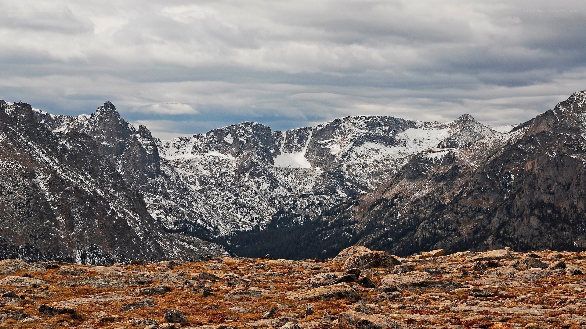 snow-capped mountains under cloudy sky
