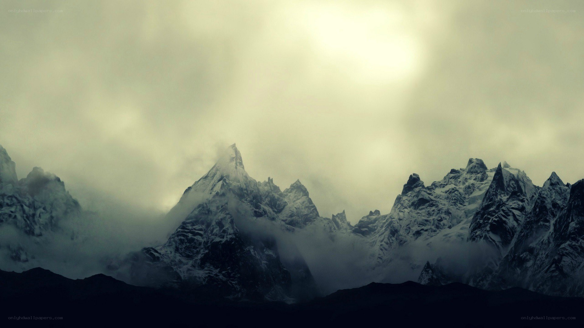snow-capped mountains under cloudy sky