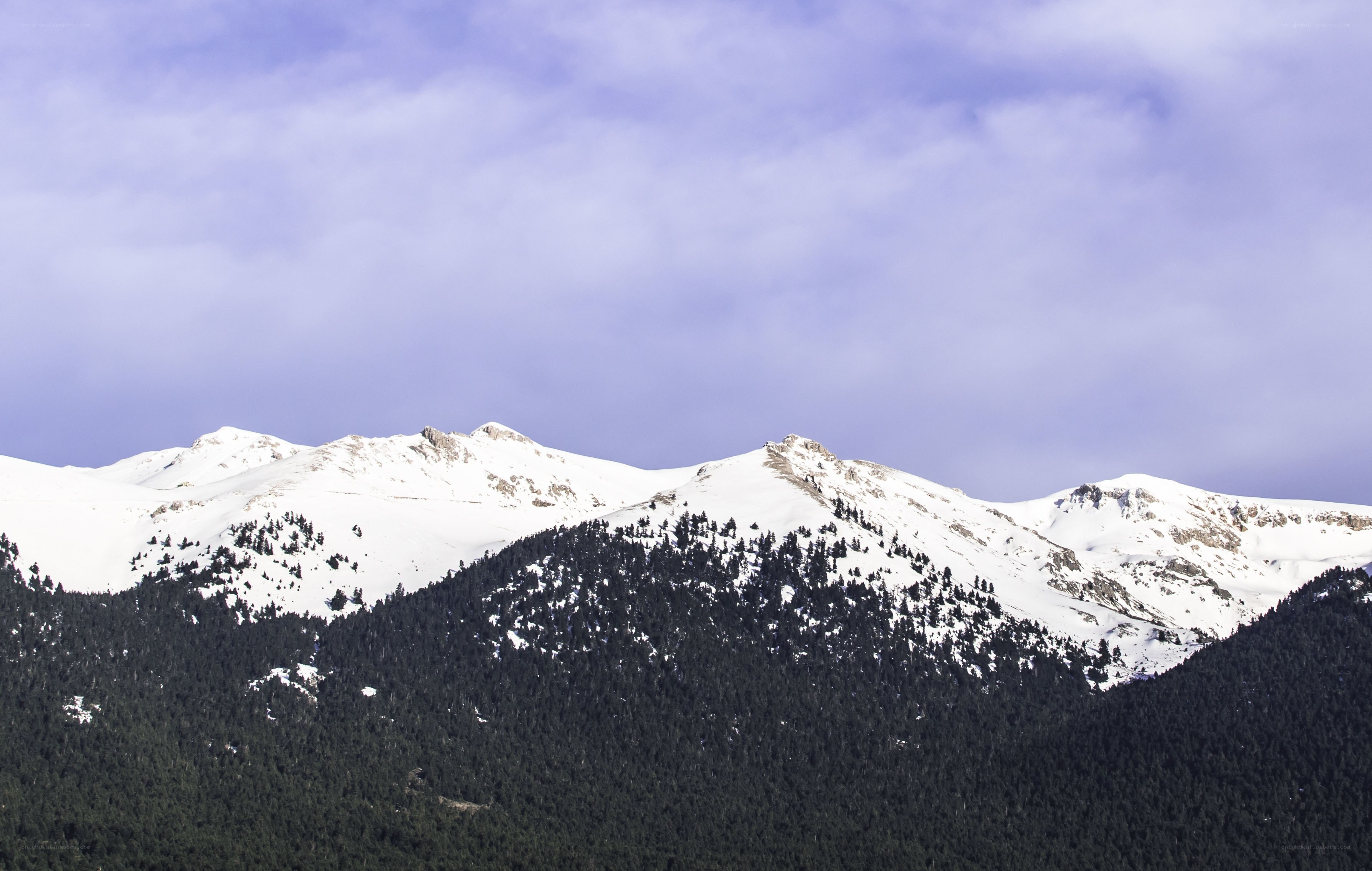 snow-capped mountains under cloudy sky