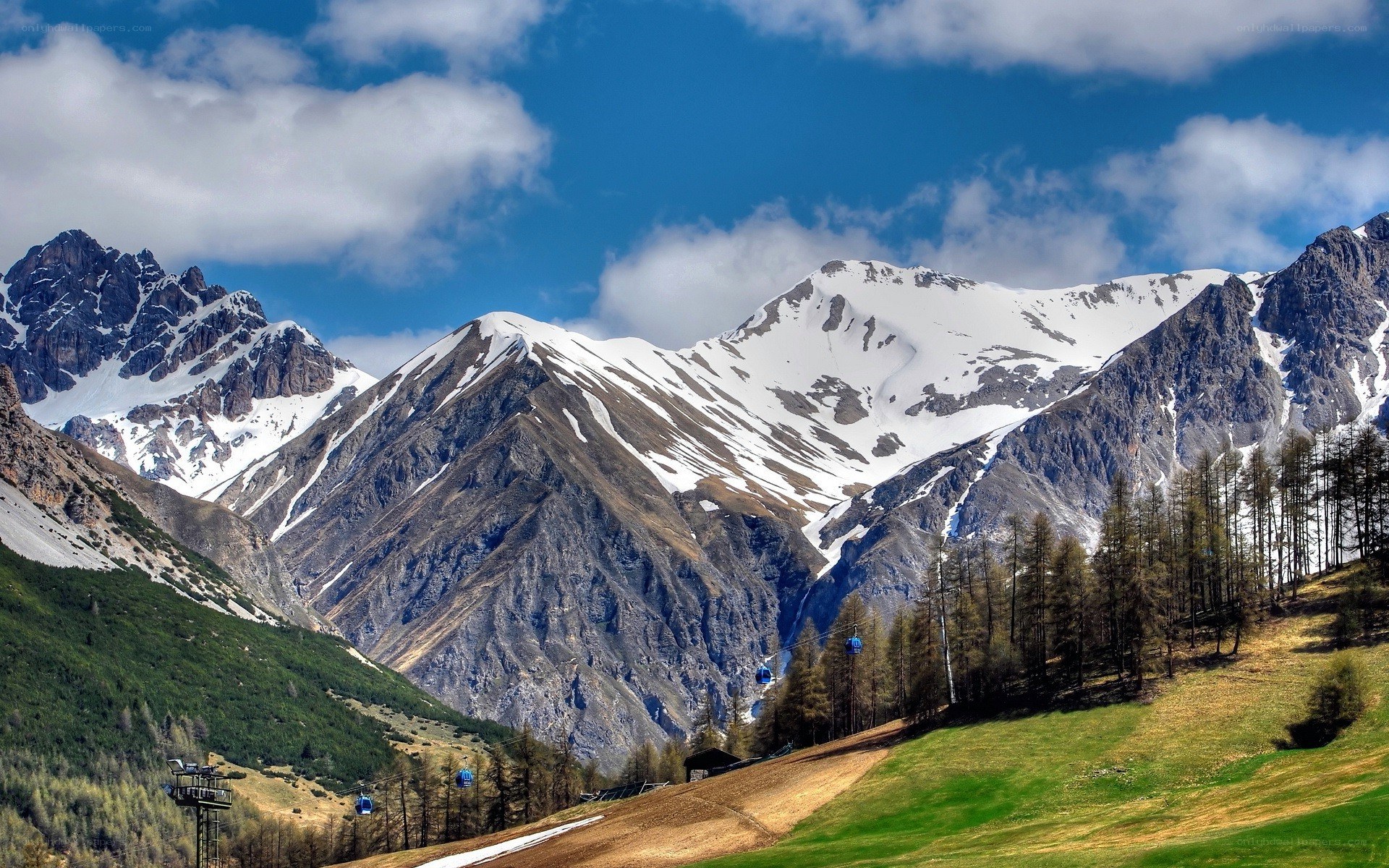Snow-capped mountains with cable cars
