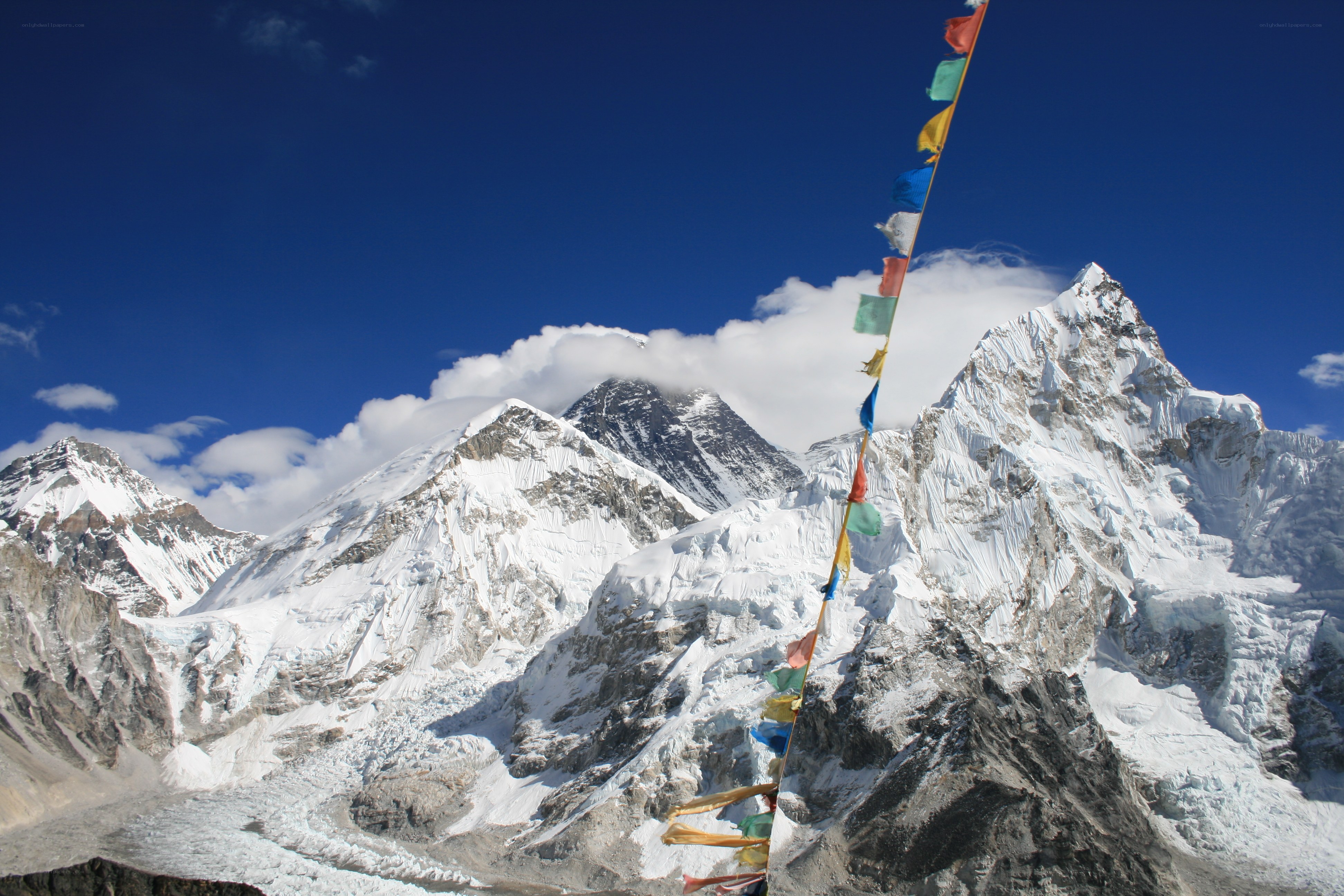 snow-capped mountains with prayer flags