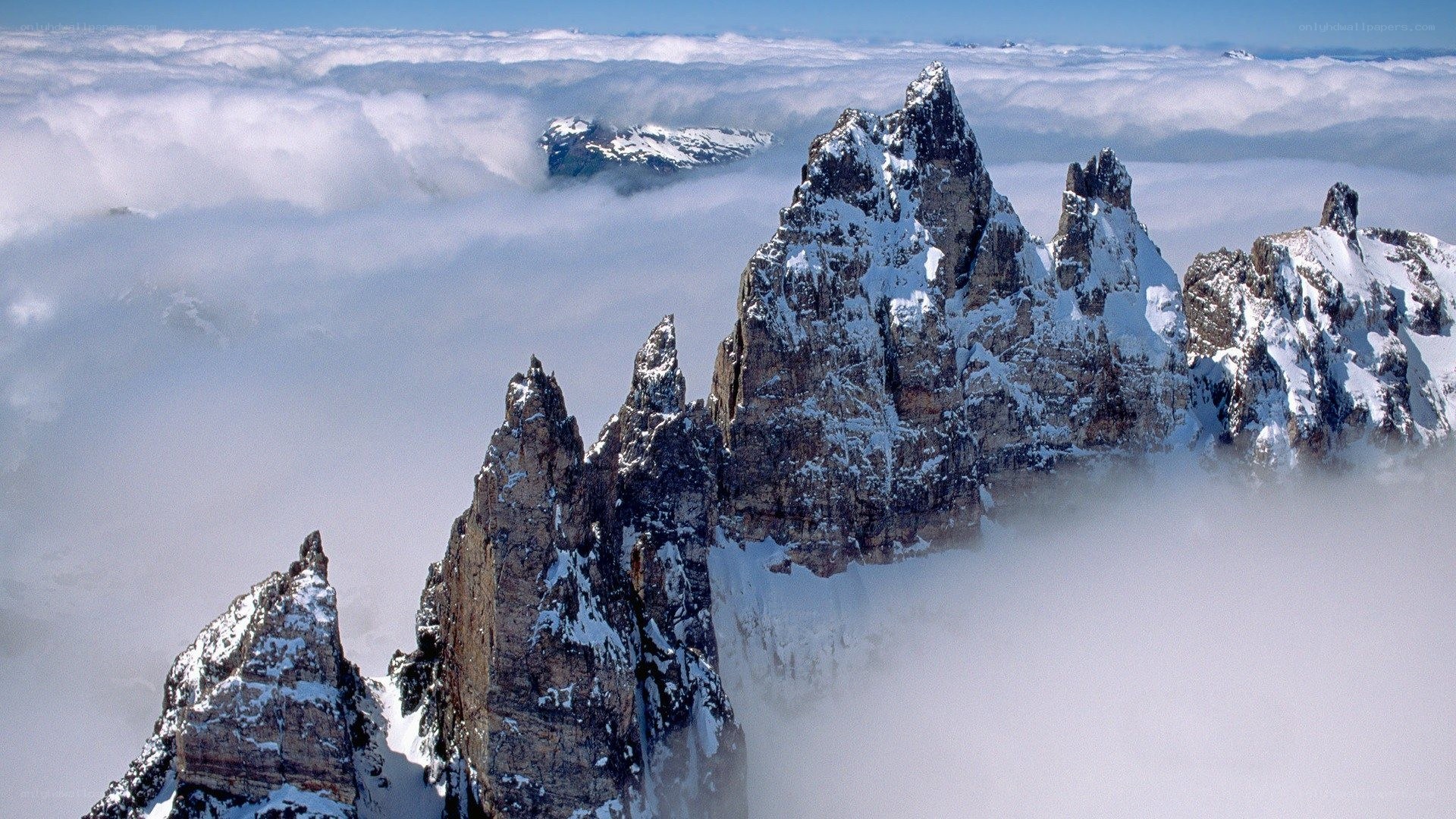 Snow-capped peaks above clouds