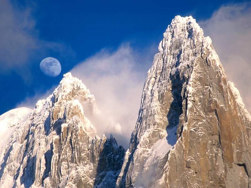 Snow-capped peaks under moonlight