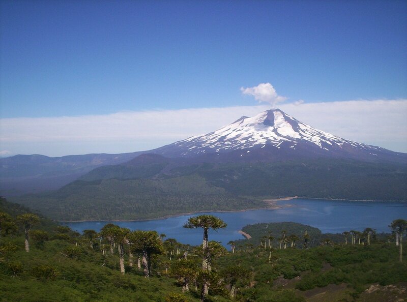 Snow-capped volcano and lake