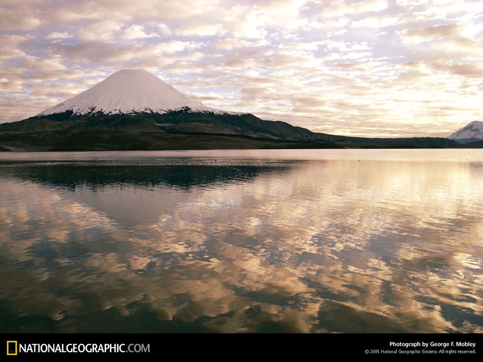Snow-capped volcano reflected in lake